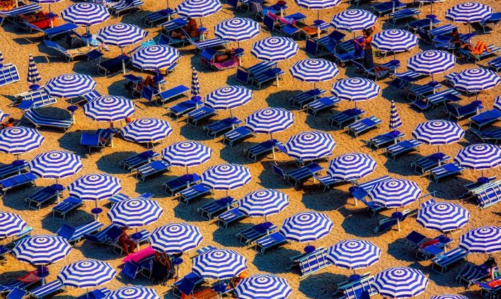 Aerial View of Blue and White Open Cottages at the Beach